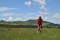 Woman and Dog Running on a Meadow Royalty Free Stock Photo