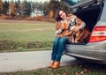 Woman with dog sit together in cat truck and warms hot tea Royalty Free Stock Photo