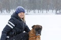 Woman with a dog on a snowy winter day on a walk. Love and friendship Royalty Free Stock Photo