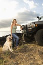 Woman and Dog by SUV at the Beach Royalty Free Stock Photo