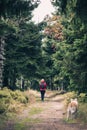 Woman and dog on trail in Izerskie Mountains, Poland Royalty Free Stock Photo