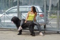 Woman and dog are waiting for public transport.