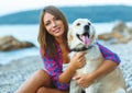 Woman with a dog on a walk on the beach Royalty Free Stock Photo