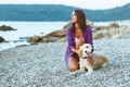 Woman with a dog on a walk on the beach Royalty Free Stock Photo