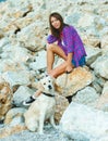 Woman with a dog on a walk on the beach Royalty Free Stock Photo