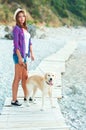 Woman with a dog on a walk on the beach Royalty Free Stock Photo