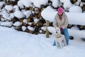 Woman with a dog on walk in a winter wood Royalty Free Stock Photo