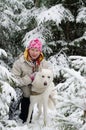 Woman with a dog on walk in a winter wood Royalty Free Stock Photo