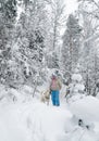 Woman with a dog on walk in a winter wood Royalty Free Stock Photo