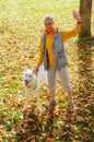 Woman with dog walking on a sunny autumn day Royalty Free Stock Photo