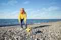 woman with a dog walks on the beach, healthy active small dog runs along the seashore, pet training