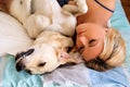 Woman with dogs at home. Handsome woman sleeping with her dog.