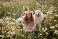 Woman dogs meadow chamomile. Woman embraces her furry friends in a serene chamomile field, surrounded by lush greenery