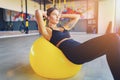 Woman doing abdominal crunches pilates exercise on exercise fitness ball at gym. Exercises for the abs. Swiss ball Royalty Free Stock Photo