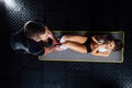 Woman doing abdominal crunches press exercise on the mat with her sports male trainer. Royalty Free Stock Photo