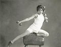Woman doing arm exercises on vaulting horse Royalty Free Stock Photo