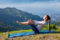 Woman doing Ashtanga Vinyasa Yoga asana Navasana - boat pose Royalty Free Stock Photo