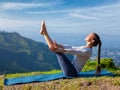 Woman doing Ashtanga Vinyasa Yoga asana Navasana - boat pose Royalty Free Stock Photo