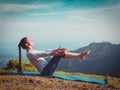 Woman doing Ashtanga Vinyasa Yoga asana Navasana - boat pose Royalty Free Stock Photo