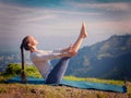 Woman doing Ashtanga Vinyasa Yoga asana Navasana - boat pose Royalty Free Stock Photo