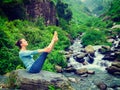 Woman doing Ashtanga Vinyasa Yoga asana Navasana - boat pose Royalty Free Stock Photo