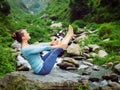 Woman doing Ashtanga Vinyasa Yoga asana Navasana - boat pose Royalty Free Stock Photo