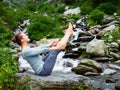 Woman doing Ashtanga Vinyasa Yoga asana Navasana - boat pose Royalty Free Stock Photo