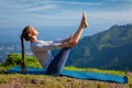 Woman doing Ashtanga Vinyasa Yoga asana Navasana - boat pose Royalty Free Stock Photo