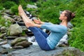 Woman doing Ashtanga Vinyasa Yoga asana Navasana outdoors Royalty Free Stock Photo