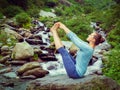 Woman doing Ashtanga Vinyasa Yoga asana outdoors