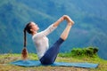 Woman doing Ashtanga Vinyasa Yoga asana outdoors