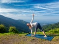 Woman doing Ashtanga Vinyasa yoga asana Parivrtta trikonasana Royalty Free Stock Photo