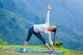 Woman doing Ashtanga Vinyasa yoga asana Utthita trikonasana