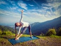 Woman doing Ashtanga Vinyasa yoga asana Utthita trikonasana