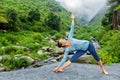 Woman doing Ashtanga Vinyasa yoga asana Utthita trikonasana