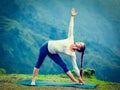 Woman doing Ashtanga Vinyasa yoga asana Utthita trikonasana