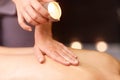 Woman doing back massage with hot oil at spa Royalty Free Stock Photo