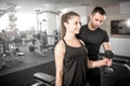 Woman doing bicep curls in gym with her personal trainer Royalty Free Stock Photo