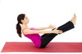 Woman doing a boat pose variation in yoga