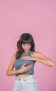 Woman doing a Breast Self-Exam checking up breast changes over pink background. Copy space Royalty Free Stock Photo