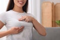 Woman doing breast self-examination at home, closeup. Space for text Royalty Free Stock Photo