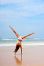 Woman doing cartwheel at the beach Royalty Free Stock Photo