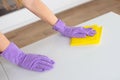 Woman doing chores at home with spray detergent suds sponge. Cropped view Royalty Free Stock Photo