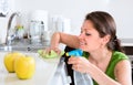 Woman doing chores in kitchen