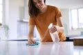 Woman Doing Chores In Kitchen At Home Cleaning And Disinfecting Surface With Spray