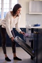 Woman Doing Chores Loading Or Emptying Dishwasher In Kitchen At Home Royalty Free Stock Photo