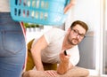 Woman doing chores while man watching tv Royalty Free Stock Photo