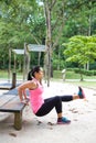 Woman doing dips on right leg in outdoor exercise park Royalty Free Stock Photo