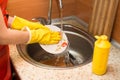 Woman doing the dishes at home kitchen.