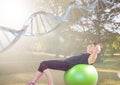 woman doing exercise with the baal in the park. DNA chain over her